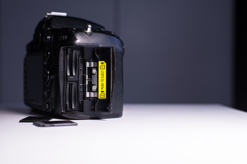 Digital DSLR camera with open memory card port,Concept of photographer work station,Close up photo