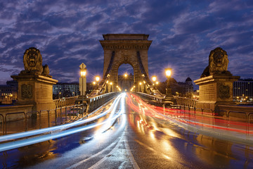 Szechenyi chain bridge in Budapest at night with traffic light trails