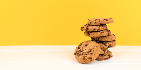 cookies with yellow background and copy space panorama - obrazy, fototapety, plakaty