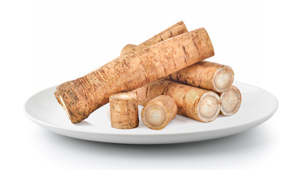 Burdock roots in a plate isolated on a white background