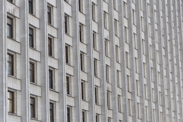 The urban building with many windows on the background