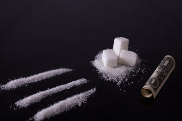 Sugar addict. Addiction of sweets and fast carbohydrates. Lines of white sugar and a dollar curled...