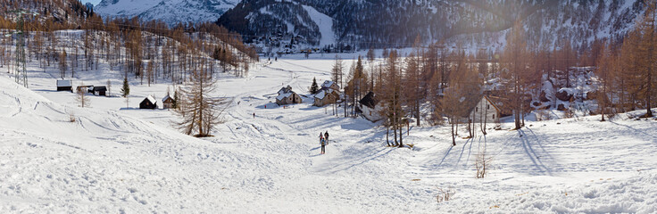 Fototapeta na wymiar mountain village nestled in the snow,
