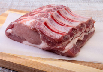 Raw pork chops, spices on cutting board. Ready for cooking.