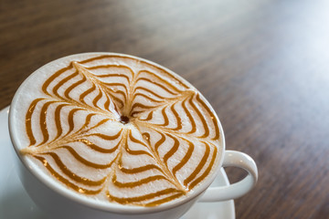 Cup of coffee latte art on wooden background