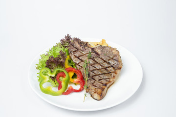 T-bone Steak served with fresh salad on white background