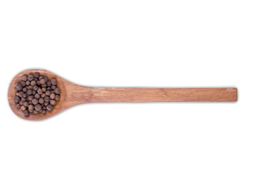 Whole allspice, jamaica pepper  on wooden spoon isolated on white background