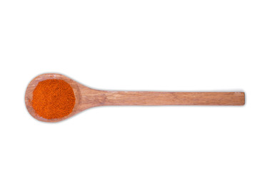 Chili pepper powder on wooden spoon isolated on white background