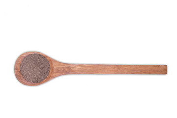 Black pepper powder on wooden spoon isolated on white background