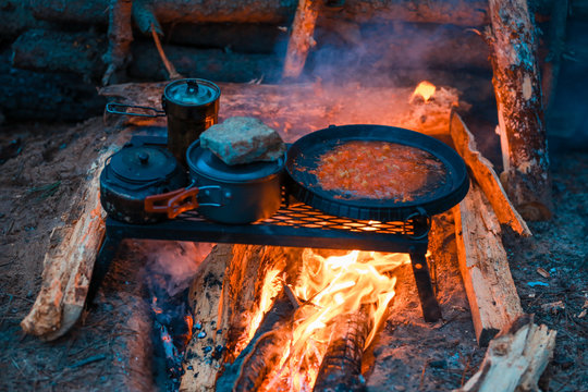 Roasted domato on campfire background