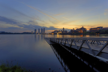 Fototapeta na wymiar Freshness and tranquility of the lake and city view at Putrajaya lakeside during sunrise