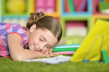 Fototapeta na wymiar Schoolgirl sleeping on exercise book