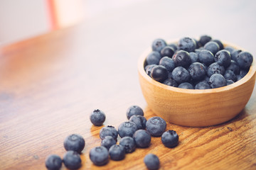 Freshly picked blueberries in wooden bowl.Bilberry on wooden Background. Blueberry antioxidant.Concept for healthy eating and nutrition.