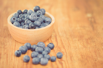 Freshly picked blueberries in wooden bowl.Bilberry on wooden Background. Blueberry antioxidant.Concept for healthy eating and nutrition.