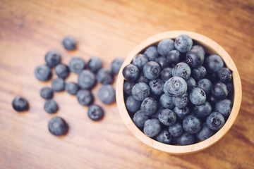 Freshly picked blueberries in wooden bowl.Bilberry on wooden Background. Blueberry antioxidant.Concept for healthy eating and nutrition.