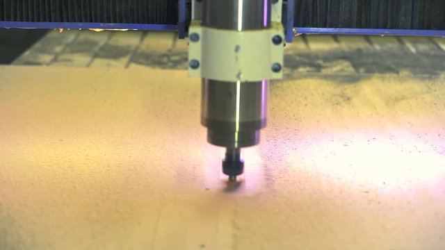 CNC machine. Movement of the milling tool on a working wooden surface.