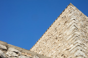 Fototapeta na wymiar Detail of mediterranean country house made of stone on a sunny day in blue background in Catalonia