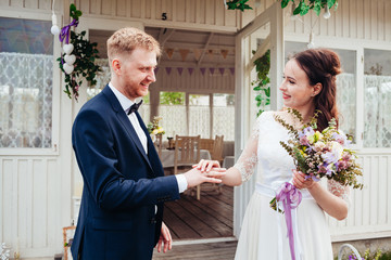 beautiful enamored couple - bride and groom on wedding day in summer