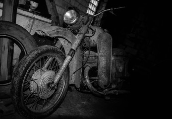 An old motorcycle sits in the garage