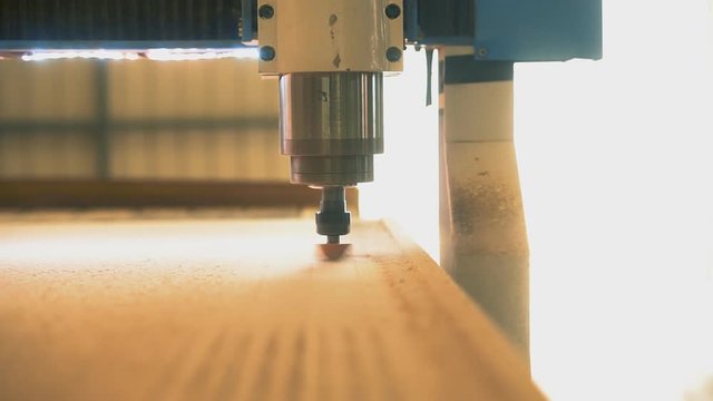 CNC machine. Movement of spindle and a milling cutter from the observer. Automation provides high accuracy of processing.