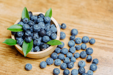 Freshly picked blueberries in wooden bowl.Bilberry on wooden Background. Blueberry antioxidant.Concept for healthy eating and nutrition.