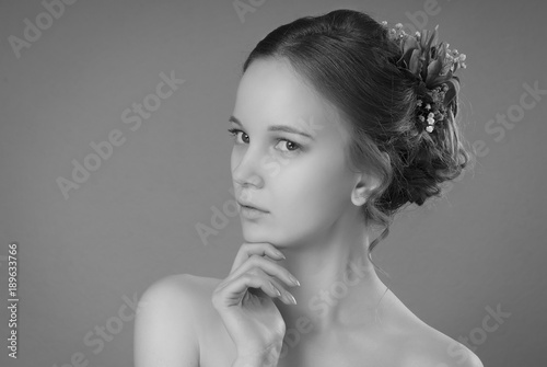 The Girl With The Hair Bun And Nude Make Up Holding A Hand Under