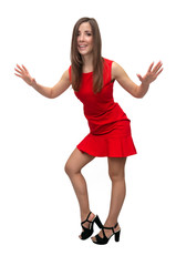 Happy surprised girl in red dress in stockings and in high heels shoes is standing is posing and is dancing on isolated on white background.