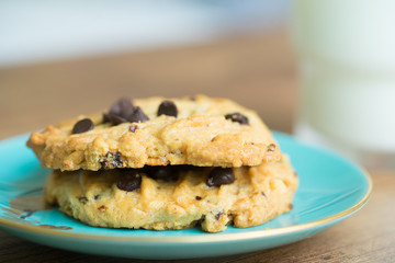Chocolate chip cookies in blue dish on old wooden table with place for text.freshly baked.Copy space.