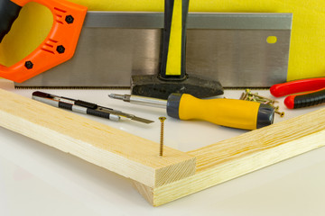 Screws screwdriver twist in wooden board. Joinery and construction work close up. Power tool operation.