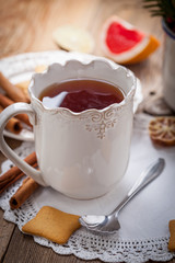 Winter hot drink with spices on wooden table.