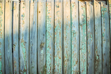 Old wooden boards. The background. Wood texture. Boards with old paint. Wooden fence.