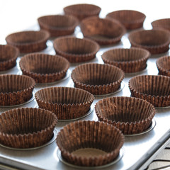 Empty muffin papers ready for baking cupcakes. Selective focus.
