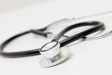 Stethoscope on table. Isolated on white background. Studio lighting. Concept for healthy and medical