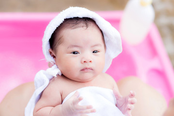 Asian newborn in mother's arm after having a bath