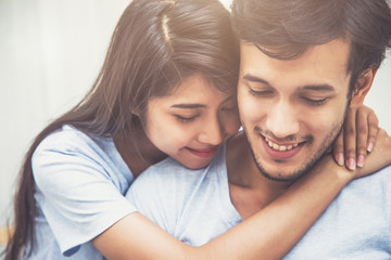 Close Up Happy Young Couple Hugging and Smiling in Warm Home - Love and Romantic Concept