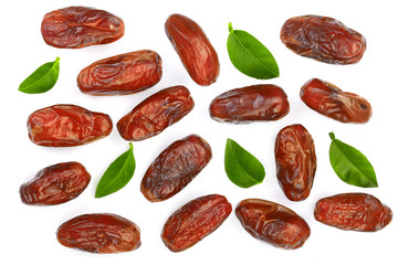 dry dates with green leaves isolated on white background. Top view. Flat lay pattern