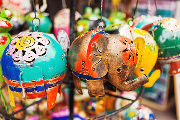 Sale of souvenirs - funny handmade puppets elephants. Bright colorful children toys and decoration...