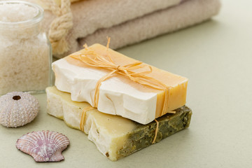 Natural organic soap with toiletries on olive green background