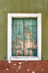 Italy, Venice, Burano island. Old window with closed old shutters.