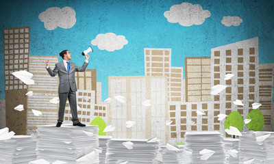 Businessman standing with megaphone.