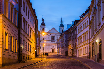 Fototapeta na wymiar Pauline church of St. Spirit and Mostowa street at night on the old town in Warsaw, Poland