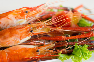 Grilled shrimp,Burn shrimp in white plate on the stone table.