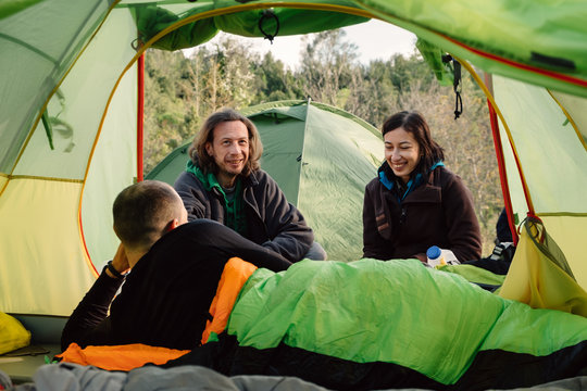 Friends travel and camping together in wild nature, smile and bo