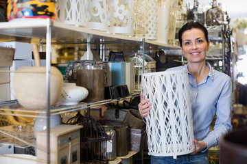 Fototapeta na wymiar Female customer holding designer item in modern store
