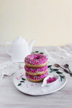 Pink doughnuts with berry filling on a light background
