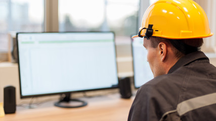 Maintenance engineer inspect relay protection system from control computer center