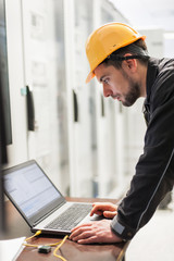 Maintenance engineer inspect relay protection system with laptop computer