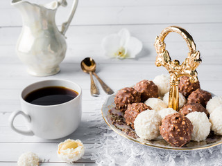 Chocolate and Coconut Candies in a Bowl on a Wooden tray Coffee Cup Orchid.