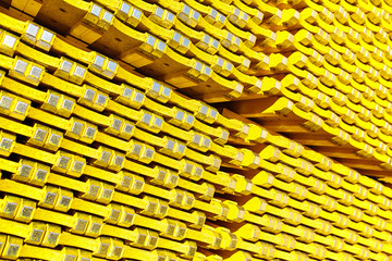 New yellow wooden formwork stacked in a warehouse in large piles.