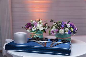 Fototapeta na wymiar Bouquet of flowers on a white table bound bow